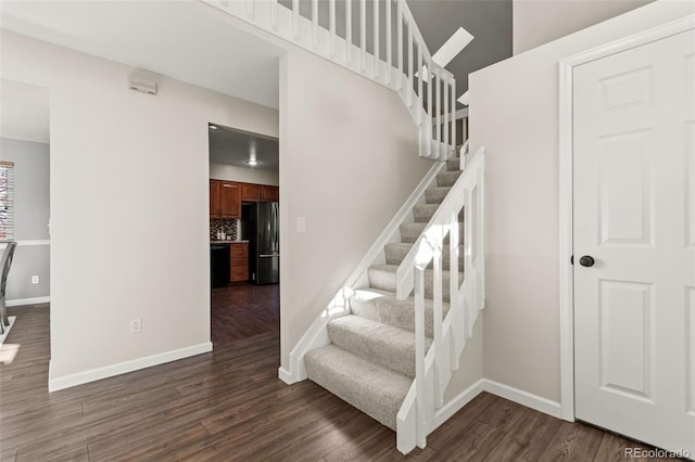 stairs featuring hardwood / wood-style floors