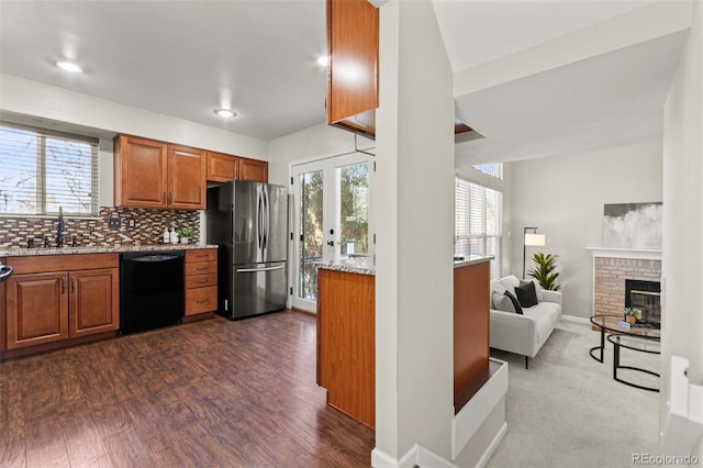 kitchen with sink, stainless steel refrigerator, dark hardwood / wood-style flooring, dishwasher, and decorative backsplash