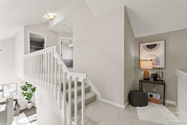 stairs with vaulted ceiling and carpet floors