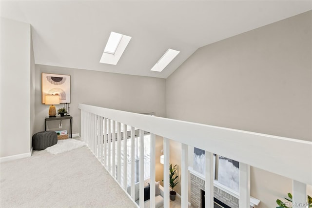 hallway with vaulted ceiling and carpet