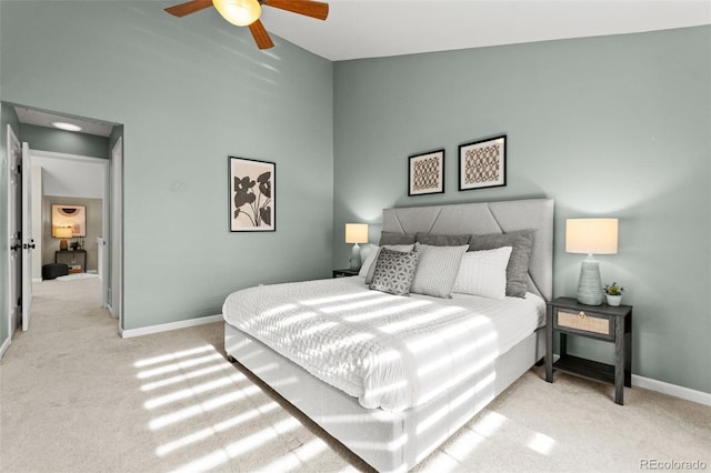 carpeted bedroom with vaulted ceiling and ceiling fan