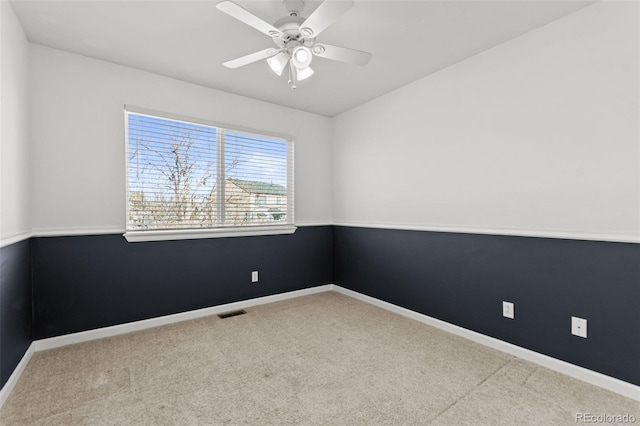 carpeted empty room featuring ceiling fan