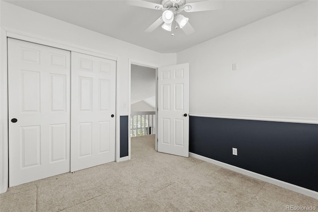 unfurnished bedroom with light colored carpet, ceiling fan, and a closet