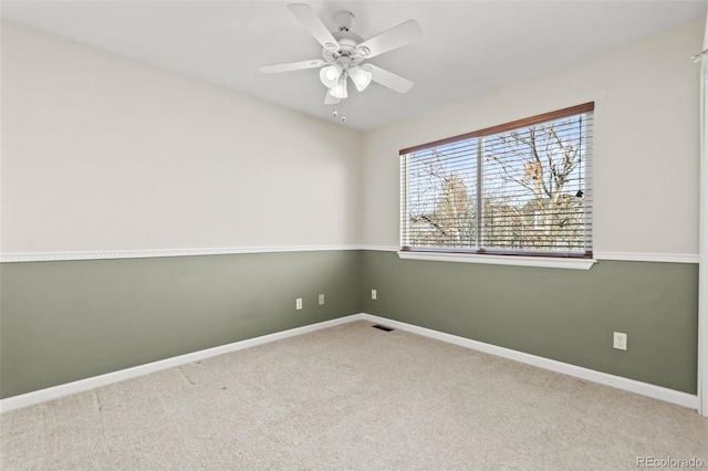 empty room featuring carpet floors and ceiling fan