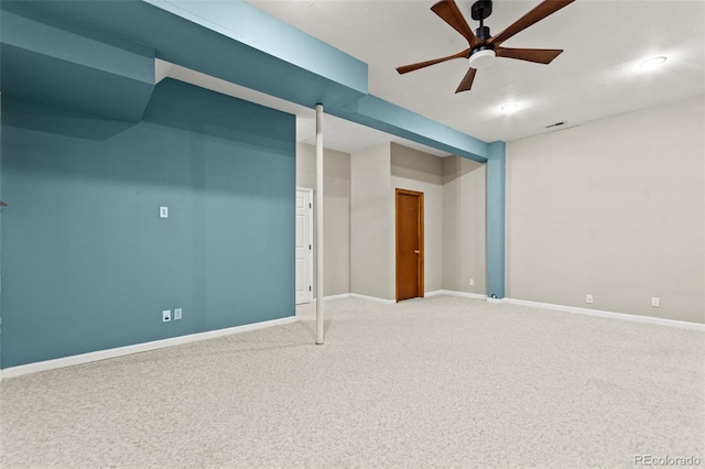 basement featuring ceiling fan and carpet flooring