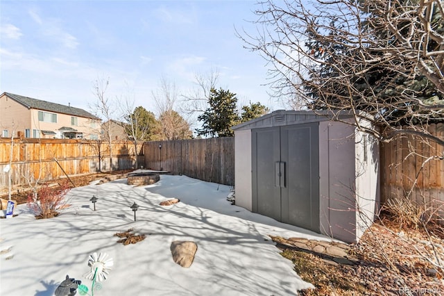 exterior space with a shed and a fire pit