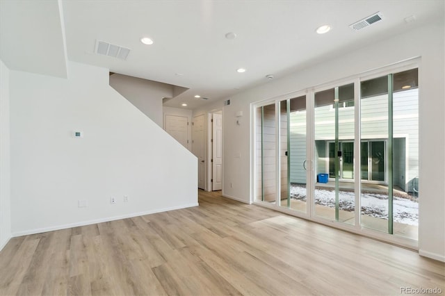 unfurnished room featuring plenty of natural light and light hardwood / wood-style flooring