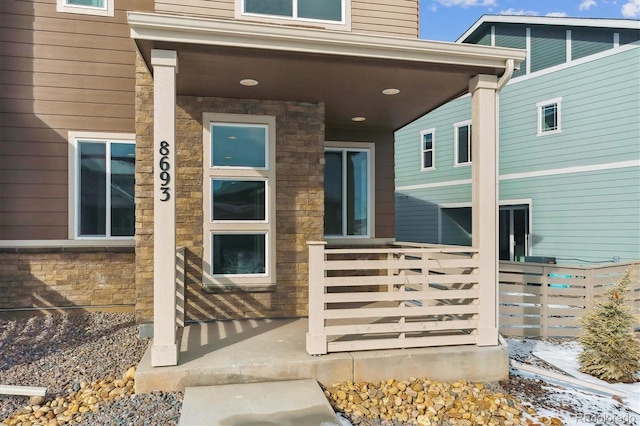 view of exterior entry with a porch