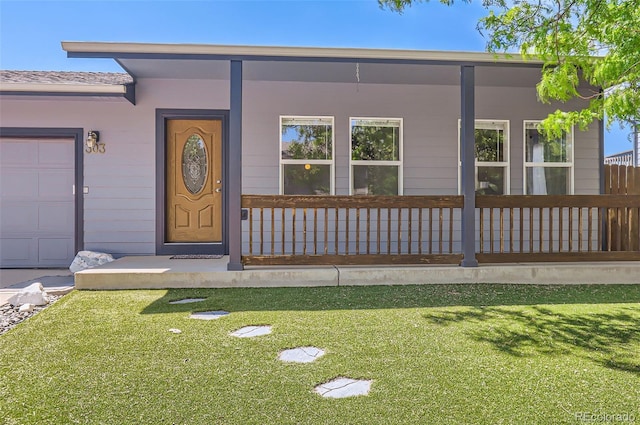 doorway to property with a lawn and a porch