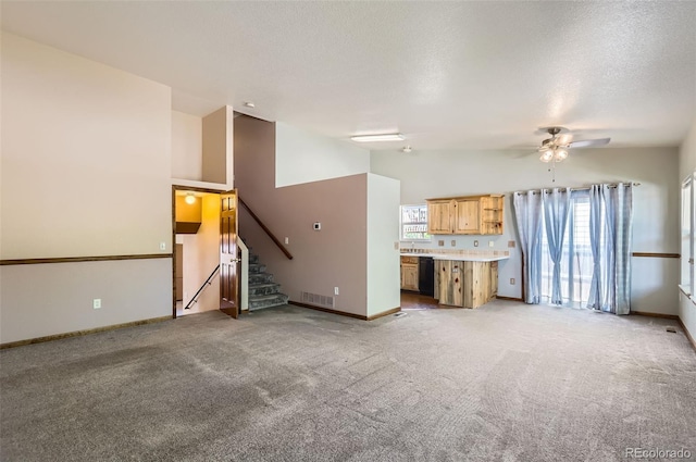 unfurnished living room with stairs, a ceiling fan, light colored carpet, baseboards, and lofted ceiling
