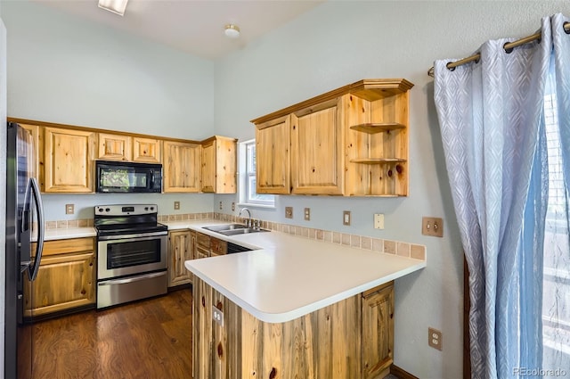 kitchen featuring stainless steel appliances, a sink, a peninsula, open shelves, and dark wood finished floors