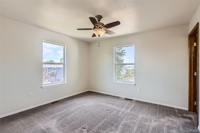 spare room featuring ceiling fan, carpet, baseboards, and a textured ceiling