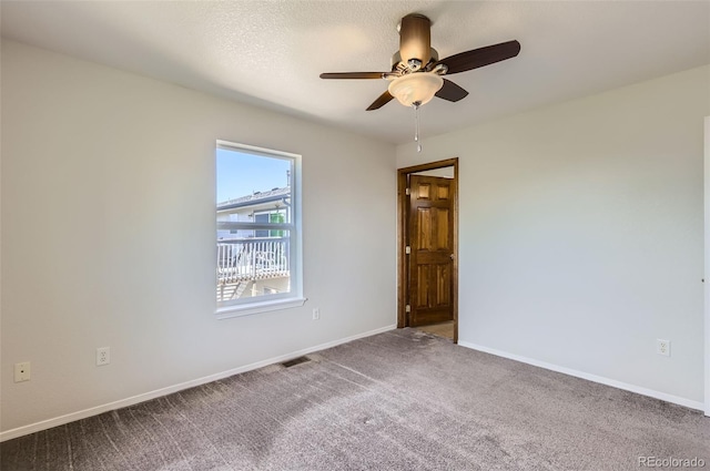 empty room with ceiling fan, baseboards, and carpet flooring