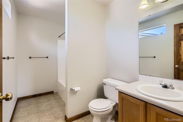 bathroom with toilet, vanity, shower / bathtub combination, and baseboards