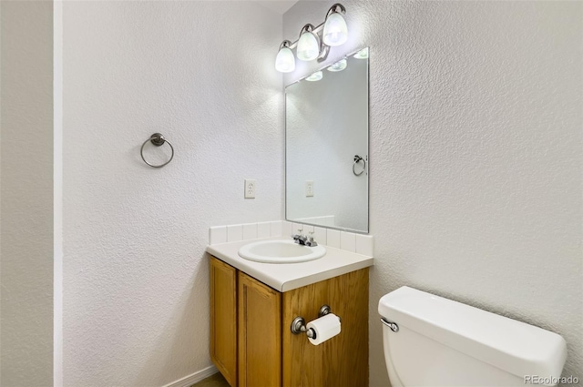 half bathroom with toilet and vanity