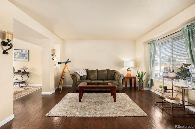 living room with dark wood finished floors and baseboards