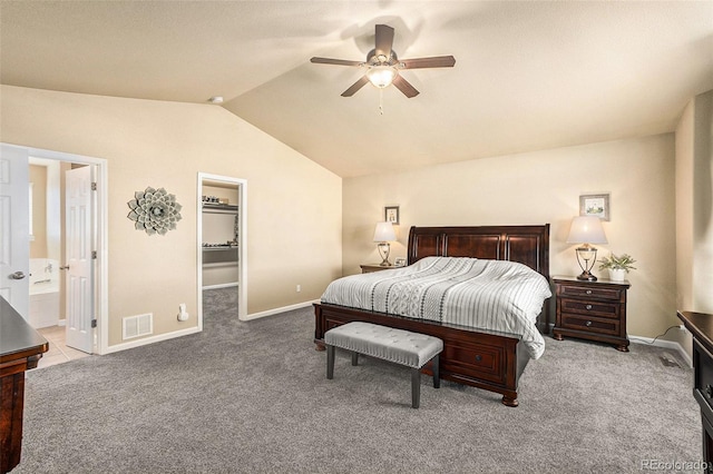 bedroom featuring lofted ceiling, visible vents, a spacious closet, light carpet, and baseboards