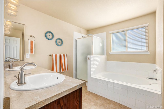 bathroom featuring a stall shower, a garden tub, a sink, and double vanity