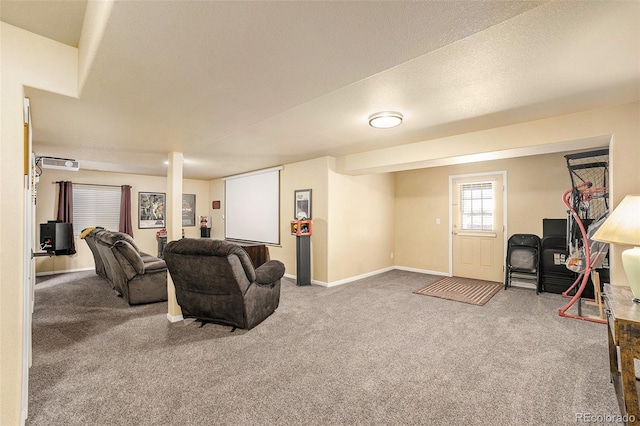 living area with carpet floors, a textured ceiling, and baseboards