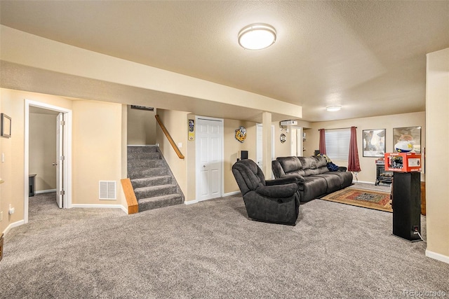 living room featuring a textured ceiling, carpet floors, visible vents, baseboards, and stairs