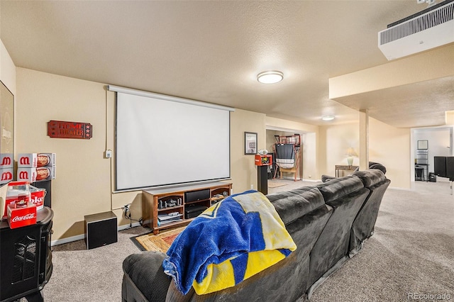 carpeted home theater room with a textured ceiling, visible vents, and baseboards