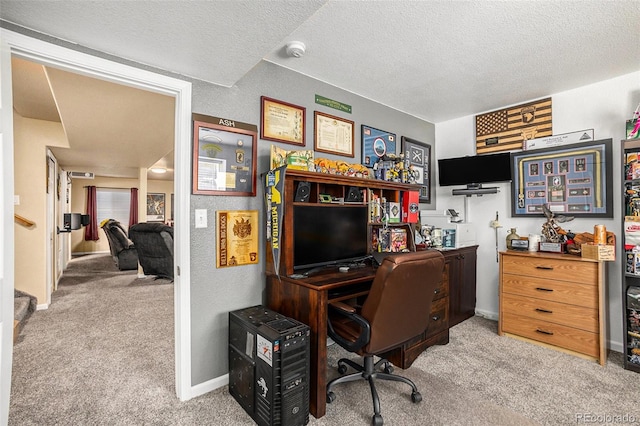 office area with baseboards, a textured ceiling, and light colored carpet