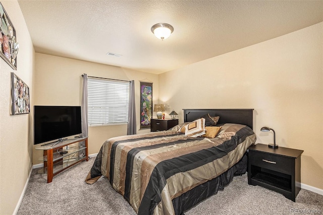 bedroom featuring light carpet, baseboards, visible vents, and a textured ceiling