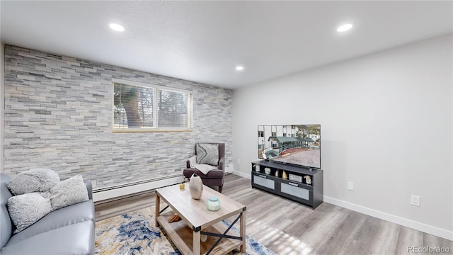 living area featuring a baseboard radiator, recessed lighting, and wood finished floors