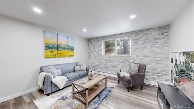 living area with a baseboard heating unit, recessed lighting, wood finished floors, and baseboards