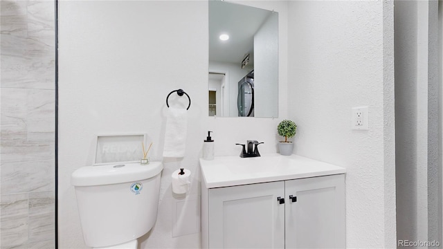 bathroom featuring toilet and vanity