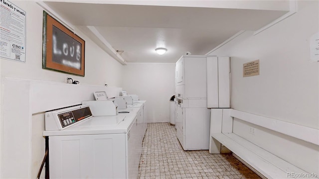 community laundry room featuring stacked washing maching and dryer