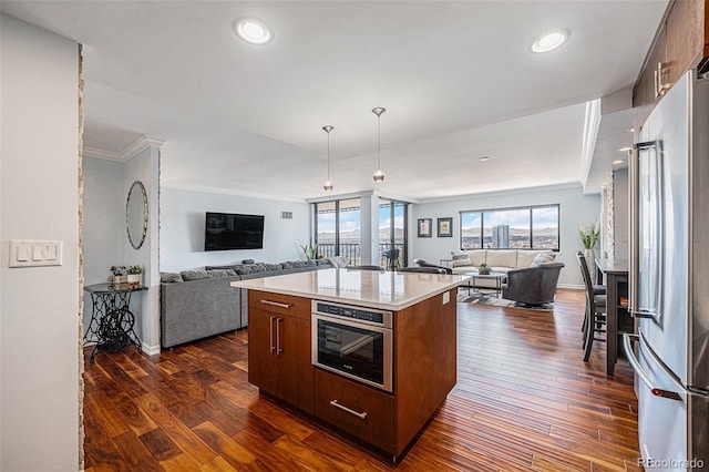 1551 Larimer St Unit 2602, Denver, CO 80202 - kitchen featuring freestanding refrigerator, light countertops, open floor plan, and dark wood-type flooring