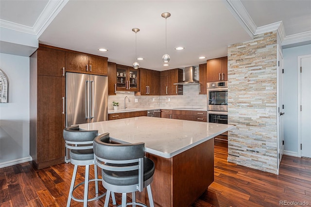 1551 Larimer St Unit 2602, Denver, CO 80202 - kitchen featuring ornamental molding, wall chimney range hood, dark wood finished floors, and appliances with stainless steel finishes