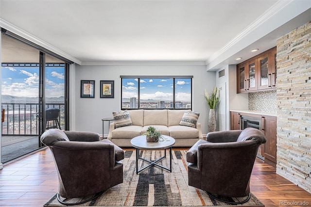 1551 Larimer St Unit 2602, Denver, CO 80202 - living area featuring crown molding, visible vents, and wood finished floors