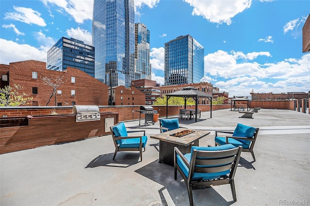 1551 Larimer St Unit 2602, Denver, CO 80202 - view of patio featuring exterior kitchen, a grill, a view of city, an outdoor fire pit, and a gazebo