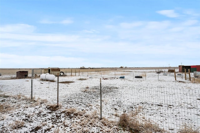 snowy yard featuring a rural view