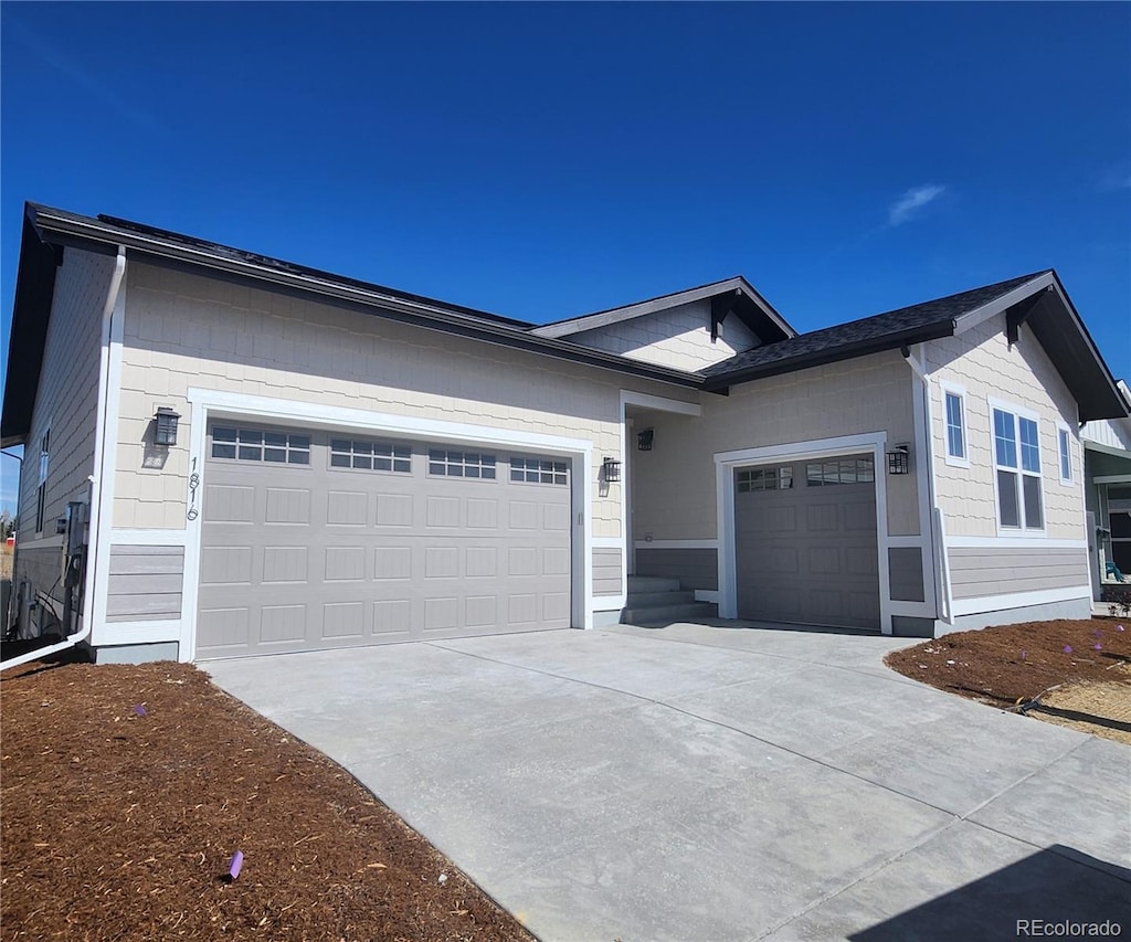 ranch-style home with driveway and an attached garage