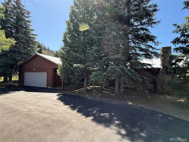 36 Woodchuck Dr, South Fork, CO 81154 - view of front of house with a detached garage, an outdoor structure, driveway, and a metal roof
