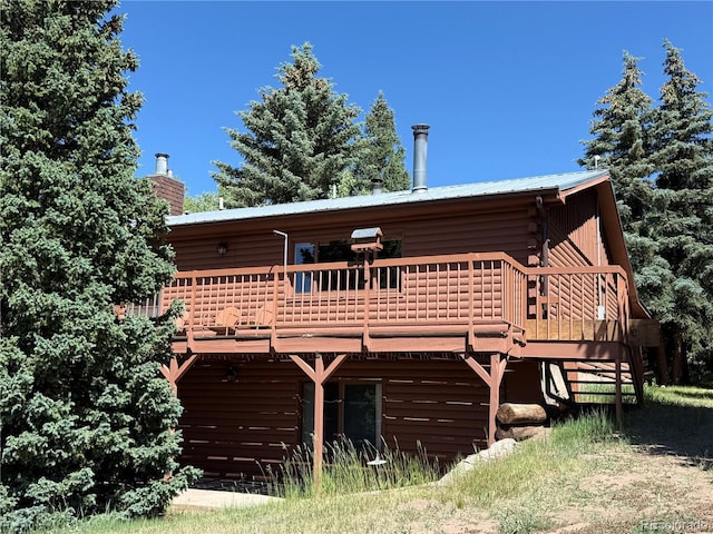 36 Woodchuck Dr, South Fork, CO 81154 - back of house with a wooden deck, a metal roof, and a chimney