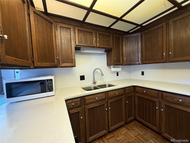 36 Woodchuck Dr, South Fork, CO 81154 - kitchen with white microwave, light countertops, and dark brown cabinetry