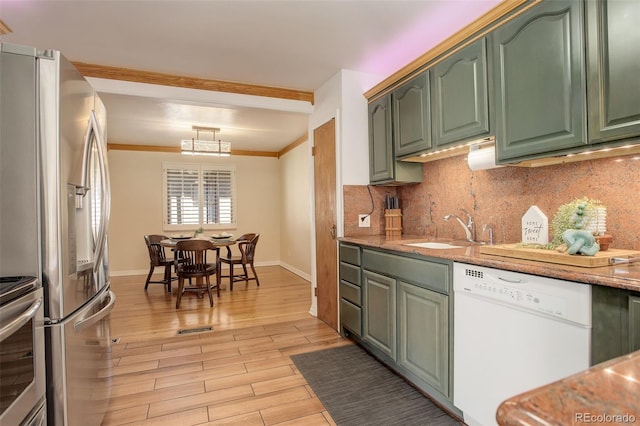 kitchen with sink, decorative backsplash, white dishwasher, stainless steel refrigerator with ice dispenser, and light hardwood / wood-style flooring