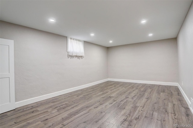 basement with light hardwood / wood-style floors