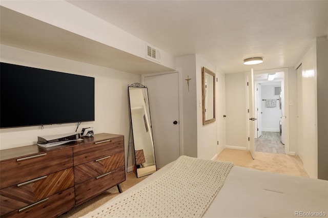 bedroom with light colored carpet