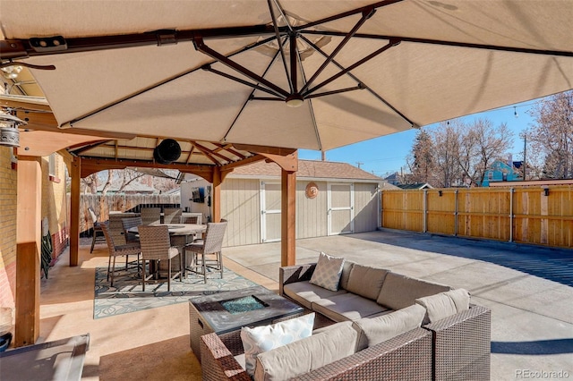 view of patio / terrace with a gazebo, a storage shed, and an outdoor living space