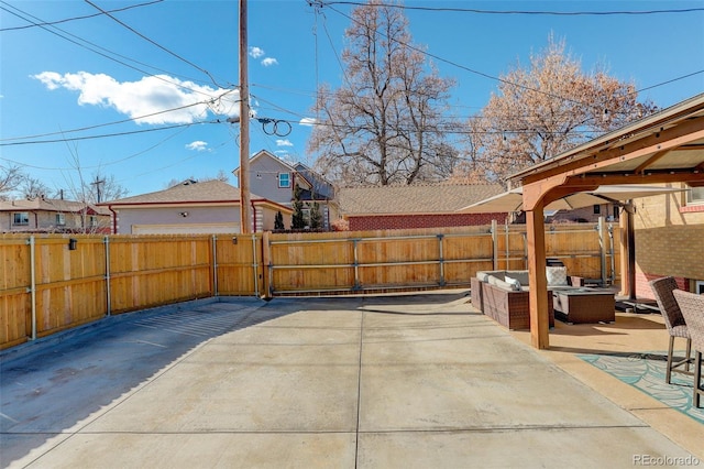 view of patio with an outdoor living space with a fire pit