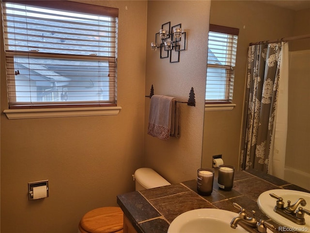 10386 Ravenswood Way, Highlands Ranch, CO 80130 - full bath with a shower with shower curtain, vanity, and a textured wall