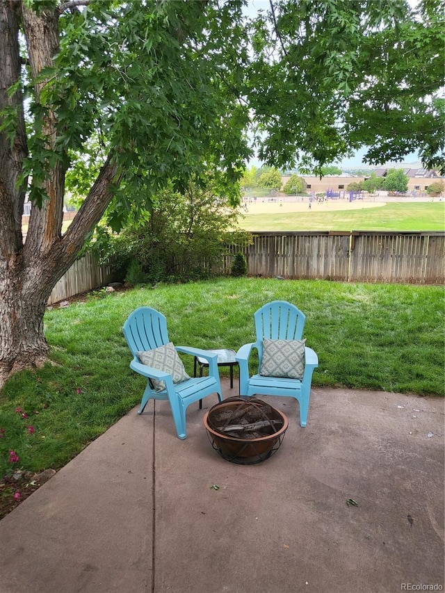 10386 Ravenswood Way, Highlands Ranch, CO 80130 - fenced backyard featuring a fire pit and a patio area