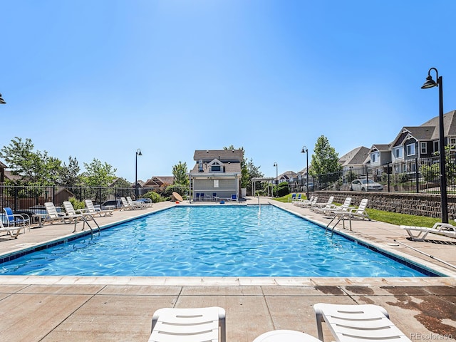 5755 S Buchanan Ct Unit E, Aurora, CO 80016 - community pool featuring a patio area and a residential view