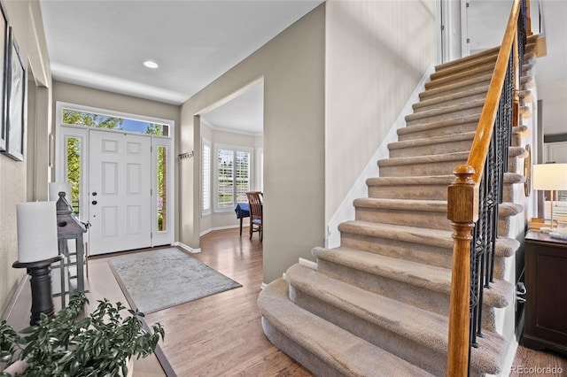entrance foyer featuring stairway, wood finished floors, baseboards, and recessed lighting