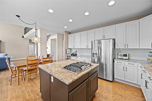 kitchen with stainless steel appliances, white cabinets, light wood-style floors, and recessed lighting